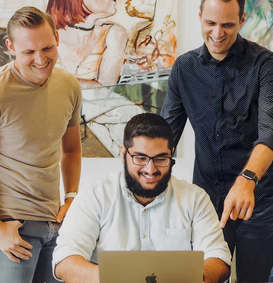 Team collaborating around computer
